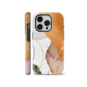 May include: A phone case with a white background and abstract shapes in shades of orange, brown, and green. The case has a gold glitter design and gold lines.