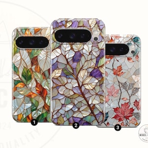 May include: Three phone cases with stained glass designs. Case 1 features autumn leaves in orange, green, and white. Case 2 has purple and white leaves. Case 3 displays red maple leaves. The cases have a glossy finish.