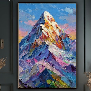 May include: Large framed oil painting of a mountain range. The artwork features a vibrant palette of blues, purples, oranges, and whites, with visible brushstrokes. The mountain peak is illuminated, set against a blue sky with clouds. The artist's name is in the top left corner.