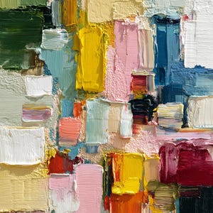 May include: Abstract oil painting with a textured surface. The artwork features a vibrant palette of colors, including yellow, pink, blue, green, and white, applied in thick brushstrokes. The composition is a close-up view of the painted surface.