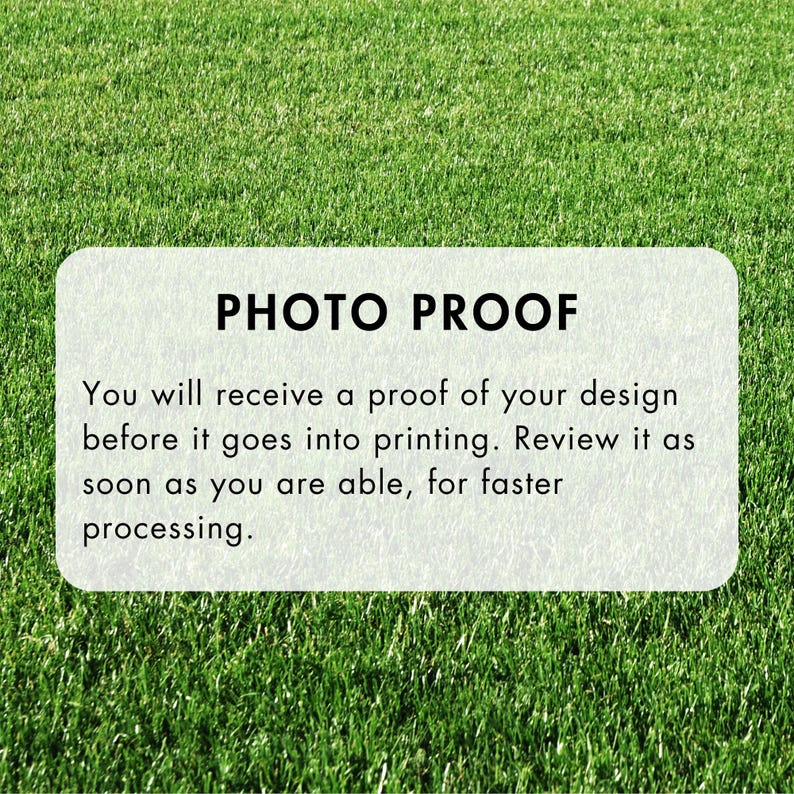May include: A rectangular, off-white sign with rounded corners, set against a backdrop of green grass. The sign reads "PHOTO PROOF" in bold, black letters. Below, smaller text explains the proofing process before printing.