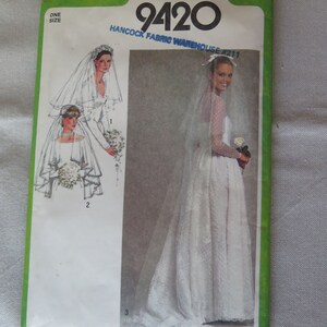 May include: A Simplicity sewing pattern for a wedding veil, pattern number 9420. The pattern shows three different styles of veils, with a lace trim and a floral design.