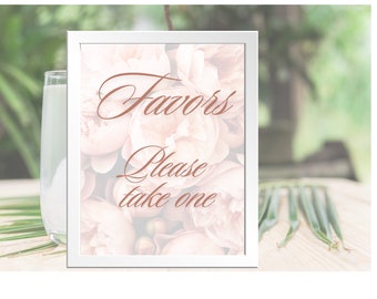 May include: White framed sign with a floral background and the text "Favors Please take one" in a copper-coloured font.