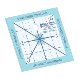 May include: A light blue square quilting ruler with a white hole and dark blue markings. The ruler has measurements in inches and the text "Cute Cuts 2 1/4" Trim-it Ruler".