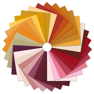 May include: A circular arrangement of square paper swatches in a variety of colors, including shades of yellow, orange, red, pink, and purple. The swatches are fanned out from a central white circle, creating a color wheel effect.