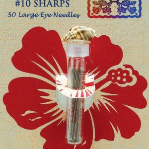 May include: A package of Roxanne #10 Sharps needles with a seashell on top, set against a red hibiscus flower design. The package includes 50 large eye needles and the text "Handmade in England."