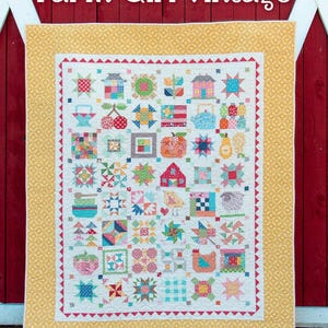 May include: A colorful quilt with a patchwork design featuring various farm-themed motifs such as houses, stars, and animals. The quilt has a white background with a yellow border and a red trim. The text "Farm Girl Vintage" is at the top.