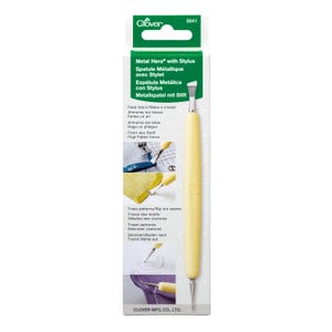 May include: A yellow Clover Metal Hera with Stylus tool for sewing and crafting. The tool has a metal tip and a yellow handle. The packaging includes text in multiple languages, including English, French, and Spanish. The tool is designed for making creases, tracing patterns, and ripping out seams.
