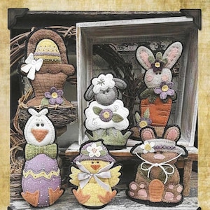 May include: A pattern sheet titled Spring Shelf Buddies an easter parade wsd #2604 by Wooden Spool Designs. It features illustrations of six felt-style figures: a basket, a sheep, a rabbit in a carrot, a duck, a chick, and a rabbit in a hat.