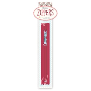 May include: A long, dark red zipper with two silver metal pulls, packaged on a white card with a floral header. The header features the text Happy ZIPPERS by Lori Holt of Bee in my Bonnet in a decorative oval frame with a light blue border.