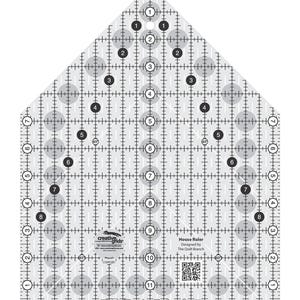 May include: A clear, house-shaped quilting ruler with black and white markings. The ruler features a grid pattern, numbered circles, and the text "House Ruler" and "Creative Grids". It is designed for quilting projects.