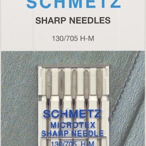 May include: A pack of Schmetz Microtex Sharp sewing machine needles, model 130/705 H-M, size 80/12. The white packaging features blue text, the Schmetz logo, and a clear plastic case containing five silver-colored metal needles arranged vertically.