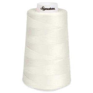 May include: A large spool of white sewing thread with a conical shape. The top of the spool features a white cap with the word Signature printed in black script. The thread is wound tightly around the spool in a smooth, uniform pattern.
