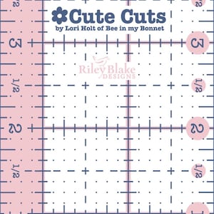 May include: Pink and white quilting ruler with blue grid lines and measurements. The ruler features the text "Cute Cuts" and "Riley Blake Designs". Numbers 1, 2, 3, and 4 are visible, along with 1/2 inch markings.