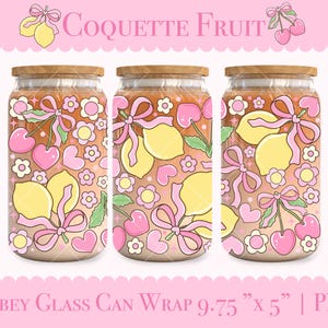 May include: Three glass can wraps with wooden lids, featuring a pink and yellow fruit design. The design includes lemons, cherries, bows, hearts, and flowers. The text "Coquette Fruit" is at the top, and "Libbey Glass Can Wrap 9.75" x 5" | PNG" is at the bottom.