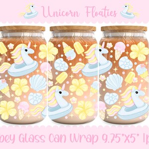 May include: Three glass can wraps with wooden lids, featuring a design of a unicorn floatie, ice cream cones, seashells, and flowers. The text "Unicorn Floaties" and "Libbey Glass Can Wrap 9.75"X5" lpng" are visible.