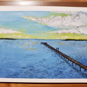 May include: A painting of a wooden pier extending out into a blue body of water. The sky is a light blue with white clouds and a yellow sunset.