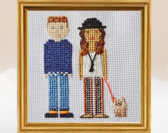 Peut inclure: Broderie au point de croix représentant un couple avec un chien. L'homme porte un pull bleu, un jean bleu et des chaussures orange. La femme porte une chemise blanche, un chapeau noir et un pantalon rayé. Le chien est brun et blanc.