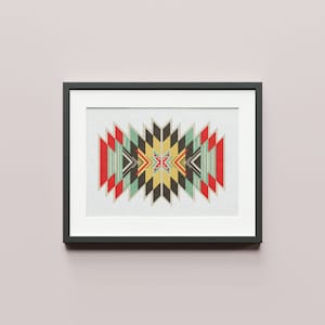 May include: A framed print featuring a geometric design in shades of red, yellow, green, and black. The design is symmetrical and features a series of triangles and squares.