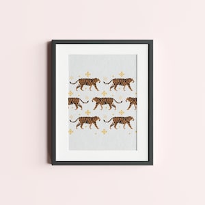 May include: Framed print with a repeating pattern of brown and orange tigers walking to the right on a light gray background with gold stars.