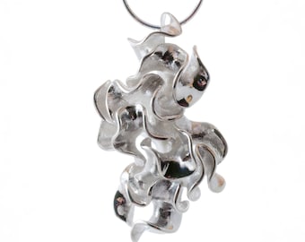 May include: A silver pendant necklace with a unique, abstract design. The pendant is made of many interconnected, flowing shapes that resemble a cluster of organic forms.