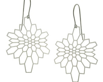 May include: A pair of silver geometric earrings with a delicate, intricate design. The earrings are made of a thin metal and have a dangling, teardrop shape.