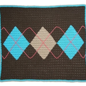 May include: A brown crocheted blanket with a diamond pattern in blue, beige, and pink.