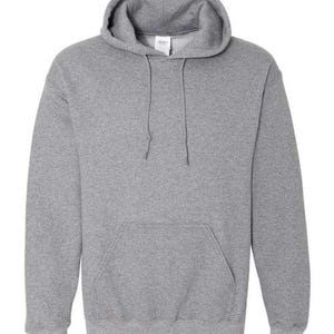 May include: A heather gray hooded sweatshirt with a drawstring and a kangaroo pocket. The sweatshirt has ribbed cuffs and hem. The hood is lined with the same material as the body of the sweatshirt. The Gildan tag is visible.