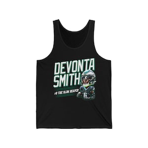 May include: Black tank top with a green and white graphic of a football player, DeVonta Smith, with the text "DeVonta Smith #6 The Slim Reaper".