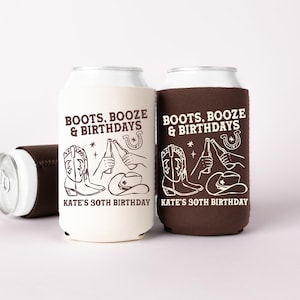 May include: Two can coolers, one cream and one brown, with the text "BOOTS, BOOZE & BIRTHDAYS" and "KATE'S 30TH BIRTHDAY". The design includes a cowboy boot, bottle, horseshoe, and cowboy hat. A third cooler is visible.