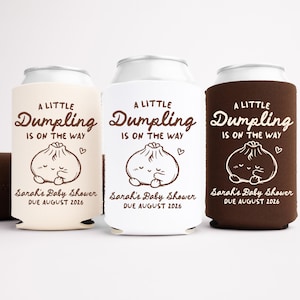 May include: A white ceramic mug with a black handle and the text "But First, Coffee" in a black, handwritten-style font. The mug is on a white surface.