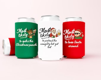 May include: Three foam can coolers in green, white, and red. The green cooler features a reindeer and the text Most likely to spike the Christmas punch. The white cooler shows Santa and the text Most likely to pretend the naughty list got lost. The red cooler displays an elf and the text Most likely to boss Santa around.
