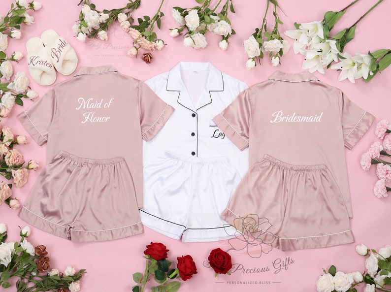May include: Three satin pajama sets in pink and white with embroidered text. One set says "Maid of Honor", one says "Bride", and one says "Bridesmaid".
