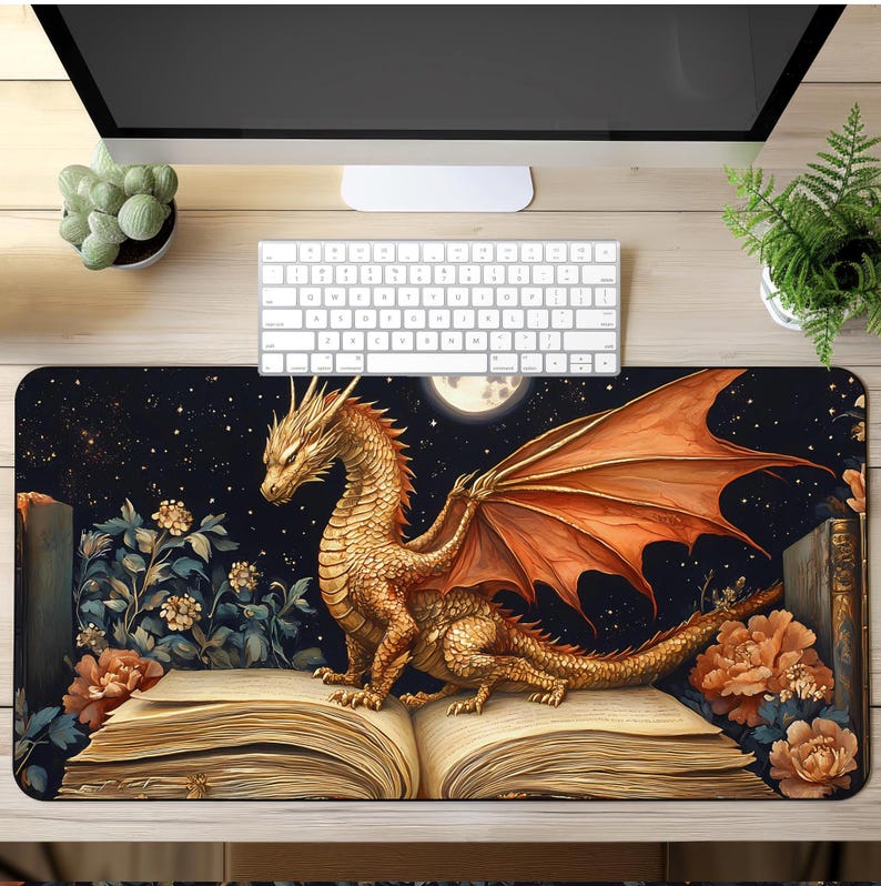 May include: A gold dragon with orange wings perched on an open book with a dark blue background and a full moon. The book is surrounded by flowers and stars.
