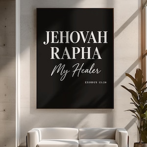 May include: A rectangular wall art print featuring a black background with white text that reads JEHOVAH RAPHA My Healer and EXODUS 15:26 in a mix of bold serif and elegant script fonts, framed in a thin dark border.