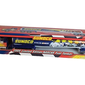May include: A 2005 Limited Edition NASCAR Fuel Tanker toy truck in its original packaging. The truck is blue, yellow, and black with the Sunoco logo. The packaging is red, blue, and yellow.