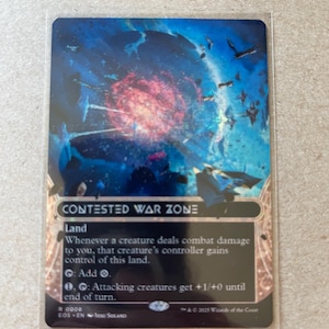 May include: A trading card titled "Contested War Zone" with a vibrant space scene. The card features a red and blue nebula with flying ships. Text on the card details its land type and abilities. The card is in a protective sleeve.