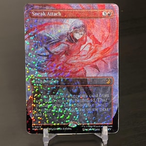 May include: A holographic Magic: The Gathering card with a red and white background. The card is titled "Sneak Attack" and has a red mana symbol and a white mana symbol in the upper right corner. The card text reads: "You may put a creature card from your hand onto the battlefield. That creature gains haste. Sacrifice the creature at the beginning of the next end step."