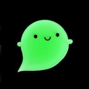 May include: A green glow-in-the-dark ghost with a smiling face.