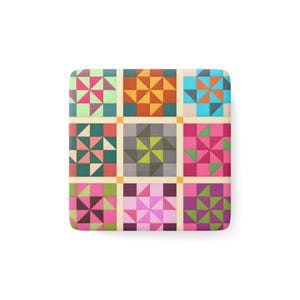 Peut inclure: Un motif de patchwork carré avec neuf blocs distincts. Chaque bloc présente un motif géométrique dans des tons de rose, vert, orange et bleu, sur un fond crème. Le design rappelle un patchwork traditionnel.