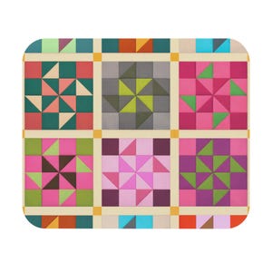 May include: A colorful, geometric patterned mat with a grid design. The mat features squares with star-like patterns in shades of pink, green, teal, and gray. The background is a light beige with yellow squares at the intersections.