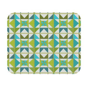 May include: A rectangular fabric quilt featuring a repeating geometric star pattern. The design consists of white, lime green, and teal blue triangles and squares, with many sections decorated with a small white polka dot pattern throughout.