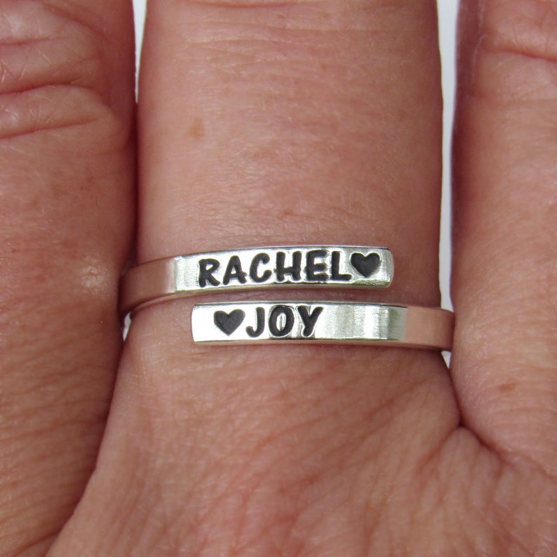 Sterling silver adjustable ring. Rings are 2.7 mm wide and 1 mm thick. Ring wraps around the finger so the 2 ends of the ring meet at the front of the finger with one end at the top and the other end on the bottom.