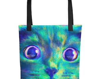 May include: A tote bag featuring a vibrant, close-up illustration of a cat face with large, wide eyes. The cat is rendered in shades of neon blue, green, and purple. The bag has two sturdy black fabric handles attached to the top edge.