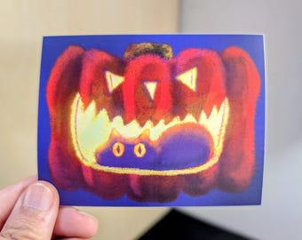 May include: A red and orange jack-o'-lantern with a toothy grin, with a black cat peeking out from inside the pumpkin.
