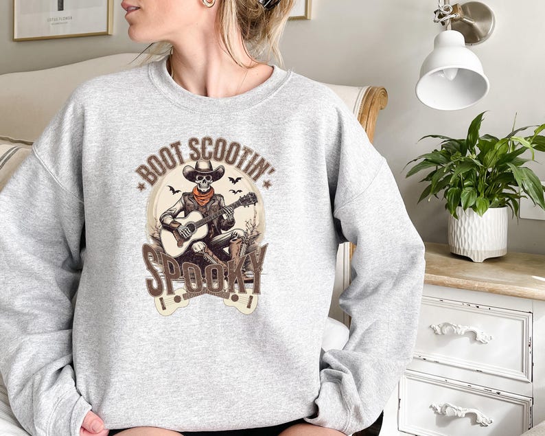 May include: Gray sweatshirt with a skeleton playing a guitar and the text "Boot Scootin' Spooky" printed on the front.