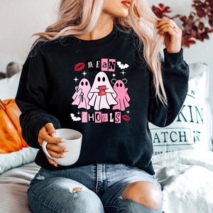 May include: Black sweatshirt with a pink graphic of three ghosts with the text "Mean Girls" and "Ghouls" in pink letters.