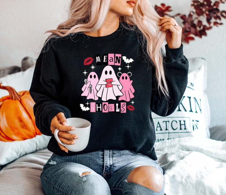 May include: Black sweatshirt with a pink graphic of three ghosts with the text "Mean Girls" and "Ghouls" in pink letters.