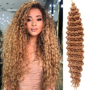Può includere: Un pacchetto di extension per capelli lunghi, di colore castano chiaro e ricci. I capelli hanno un motivo a riccioli sciolti e ondulati.
