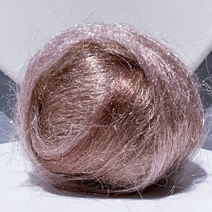 May include: A ball of light pink hair fibers with a shimmery finish.